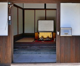 Casa antica e Hina davanti a paravento in oro all'entrata